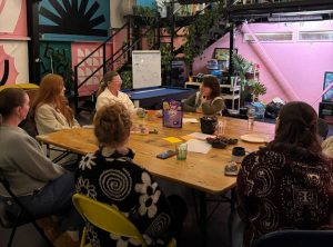 a group of people sat round a table discussing thoughts at the Death Cafe